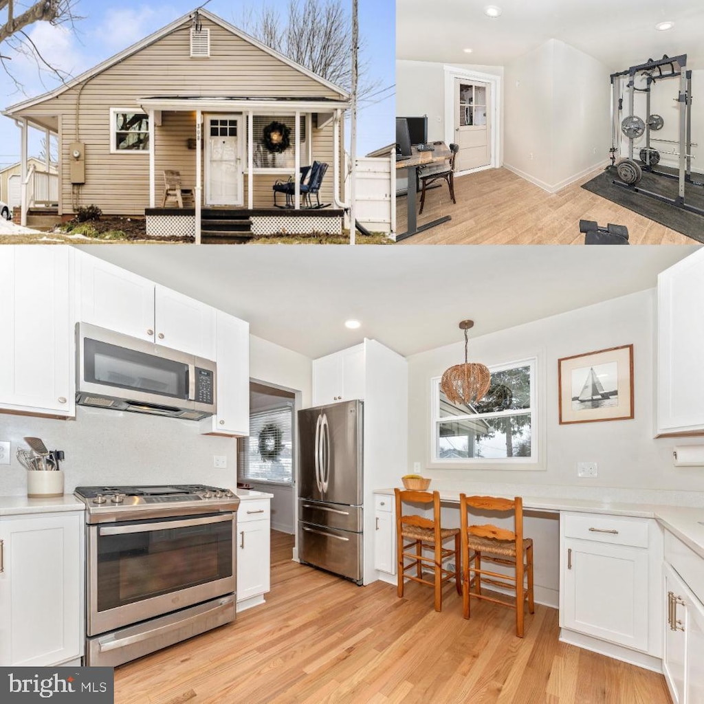 kitchen featuring white cabinetry, hanging light fixtures, a healthy amount of sunlight, light wood-type flooring, and appliances with stainless steel finishes