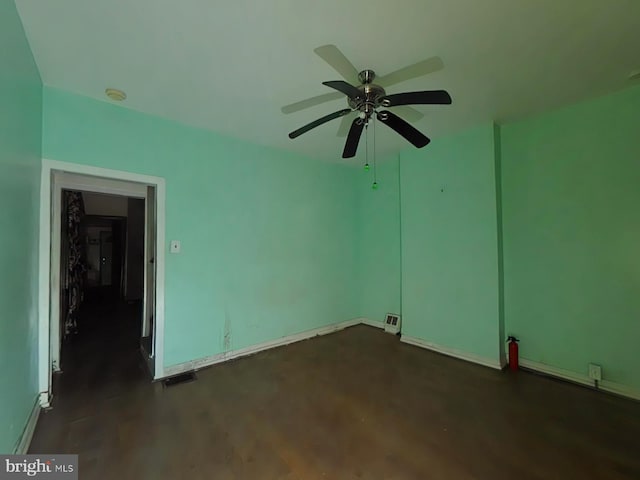 unfurnished room with dark hardwood / wood-style flooring