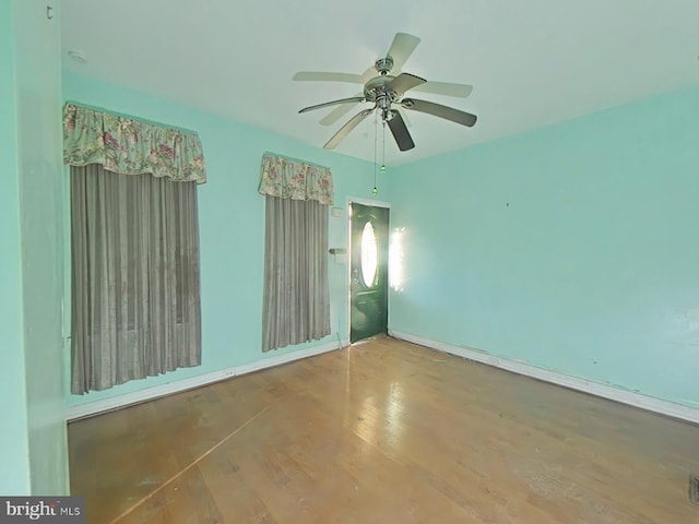 empty room with ceiling fan and hardwood / wood-style floors