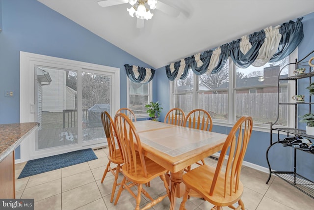 tiled dining area with vaulted ceiling and ceiling fan