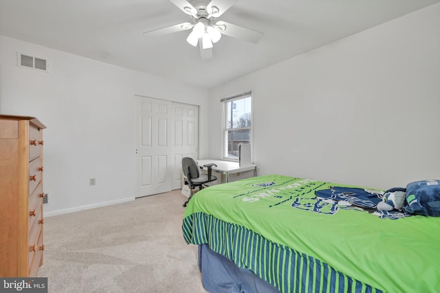 carpeted bedroom featuring ceiling fan and a closet