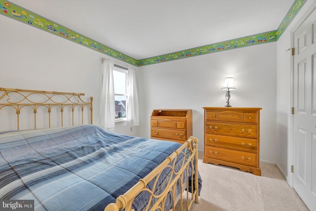 bedroom featuring light colored carpet