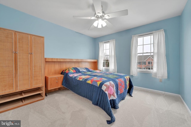 bedroom with ceiling fan and light colored carpet