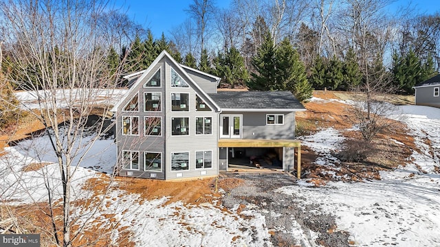 view of snow covered rear of property