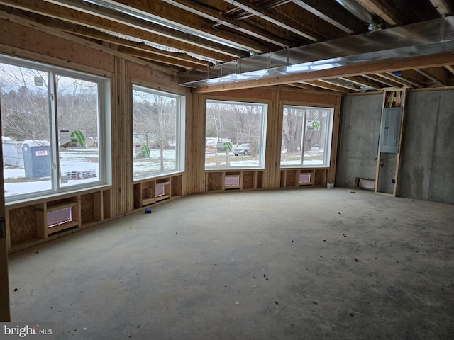 miscellaneous room featuring electric panel, a wall mounted AC, and plenty of natural light