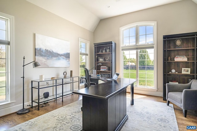 home office featuring lofted ceiling and wood-type flooring