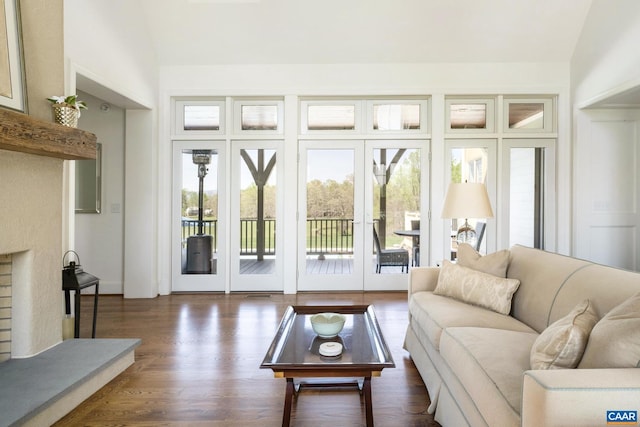 living room featuring french doors, dark hardwood / wood-style floors, and lofted ceiling