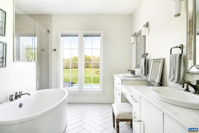 bathroom featuring plenty of natural light, vanity, and independent shower and bath