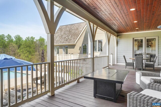 wooden deck featuring a beach view