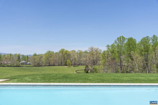 view of swimming pool featuring a lawn