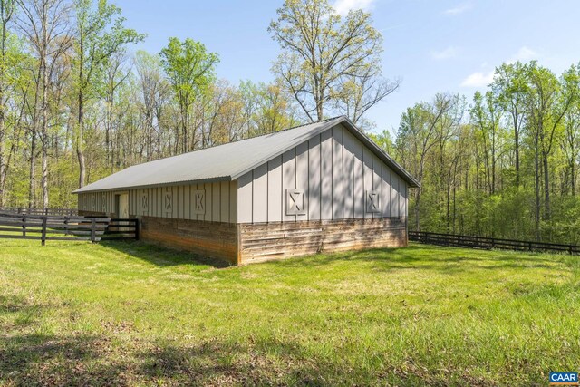 view of side of property with a yard and an outbuilding