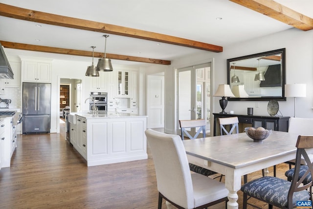 dining area featuring french doors, beam ceiling, and dark hardwood / wood-style flooring