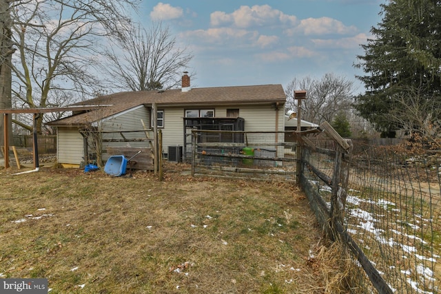 view of outdoor structure featuring central AC and a lawn