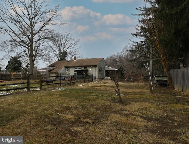 back of property featuring a yard