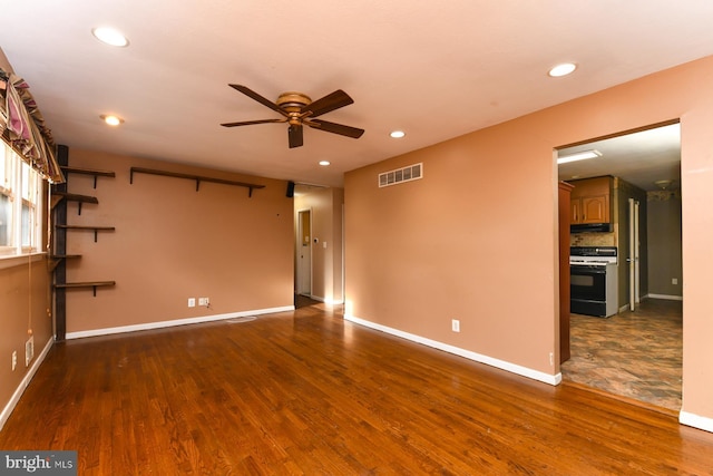 unfurnished room featuring ceiling fan and dark hardwood / wood-style flooring