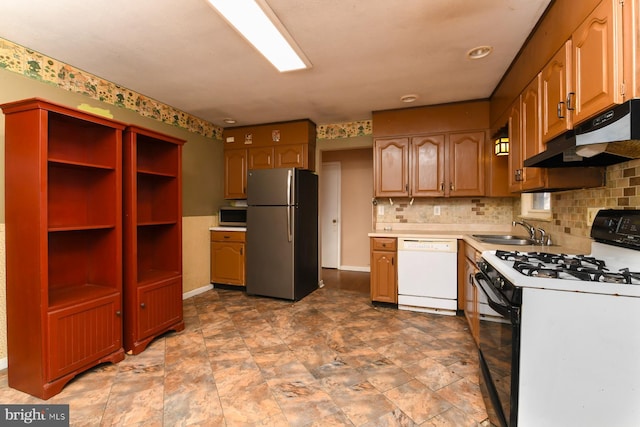 kitchen featuring backsplash, appliances with stainless steel finishes, and sink