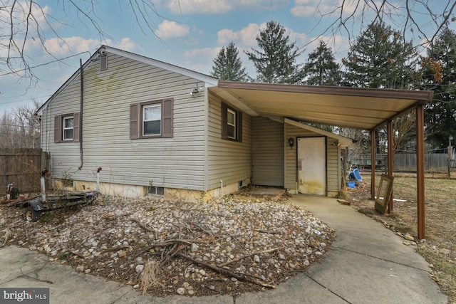 view of property exterior with a carport