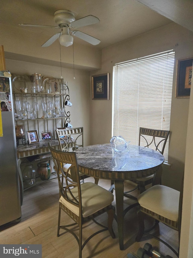 dining room featuring ceiling fan and light hardwood / wood-style floors