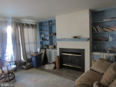 living room with hardwood / wood-style flooring and built in features