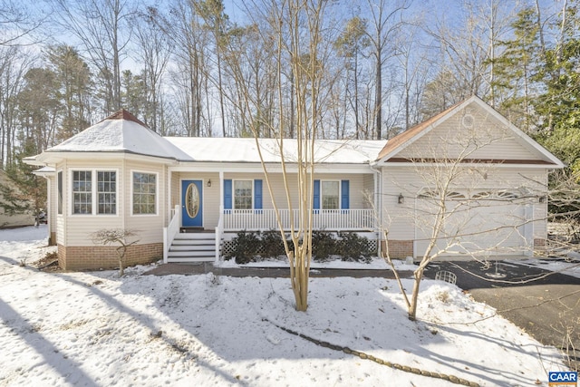 single story home featuring a porch and a garage