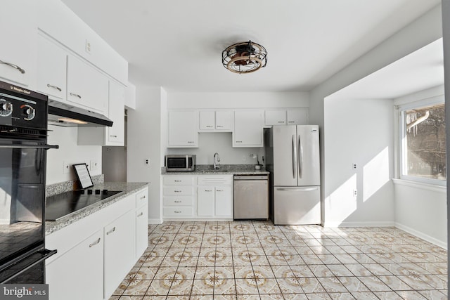 kitchen with sink, light tile patterned flooring, black appliances, and white cabinetry