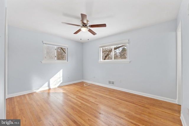 unfurnished room with ceiling fan and light wood-type flooring