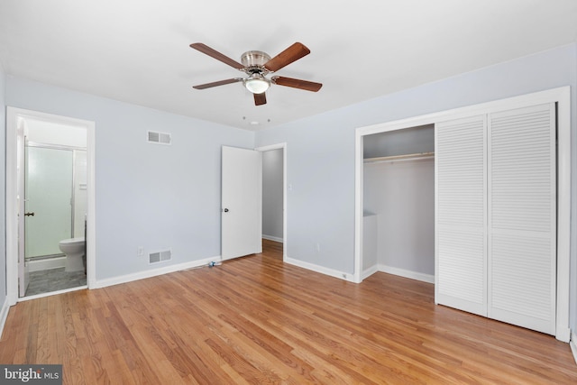 unfurnished bedroom with light hardwood / wood-style floors, a closet, ensuite bath, and ceiling fan