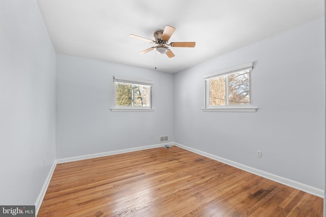 spare room featuring light wood-type flooring and ceiling fan