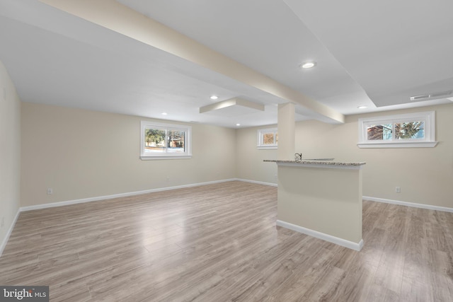 basement featuring light wood-type flooring