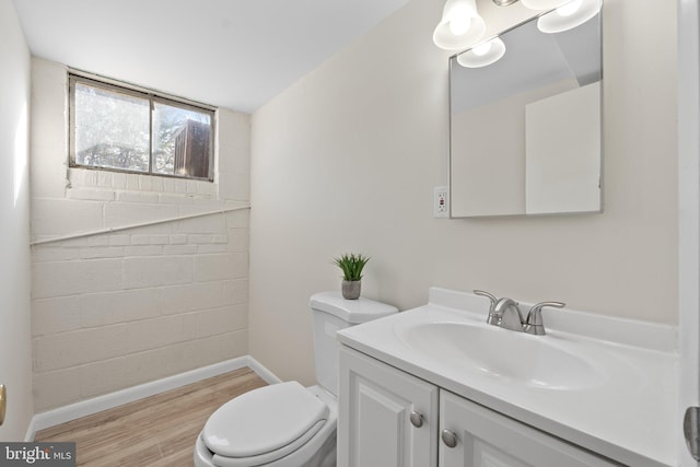 bathroom with vanity, hardwood / wood-style flooring, and toilet