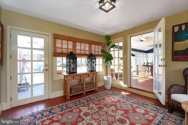 doorway featuring tile patterned flooring and baseboards