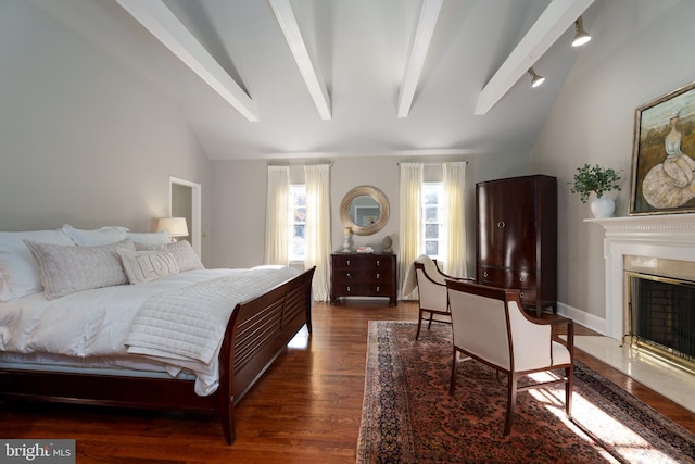 bedroom with dark wood-style flooring, vaulted ceiling with beams, baseboards, and a premium fireplace