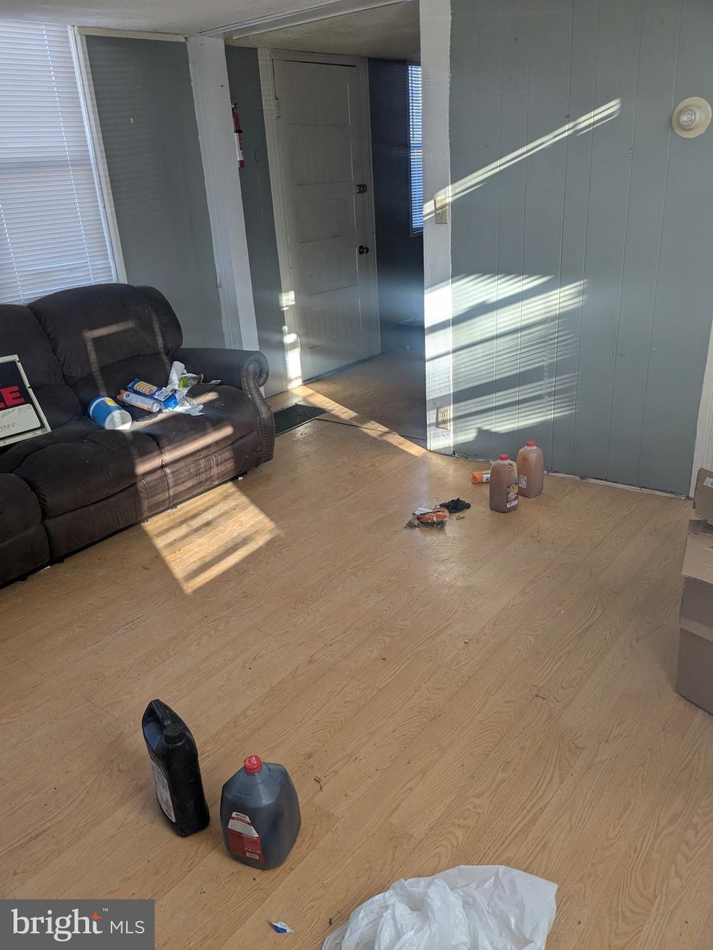 living room with hardwood / wood-style flooring and wooden walls