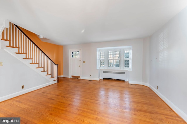 foyer featuring radiator and light hardwood / wood-style floors