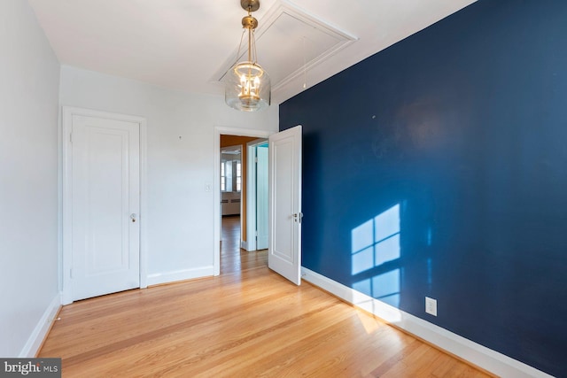 empty room with hardwood / wood-style flooring and baseboard heating