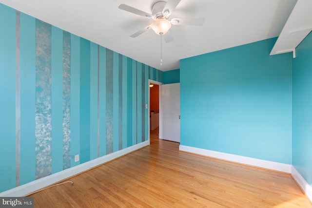 empty room with ceiling fan and light wood-type flooring