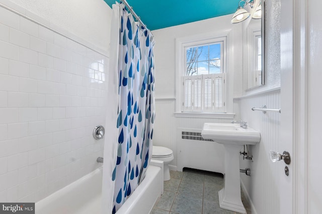 full bathroom featuring sink, shower / tub combo, radiator heating unit, tile patterned floors, and toilet