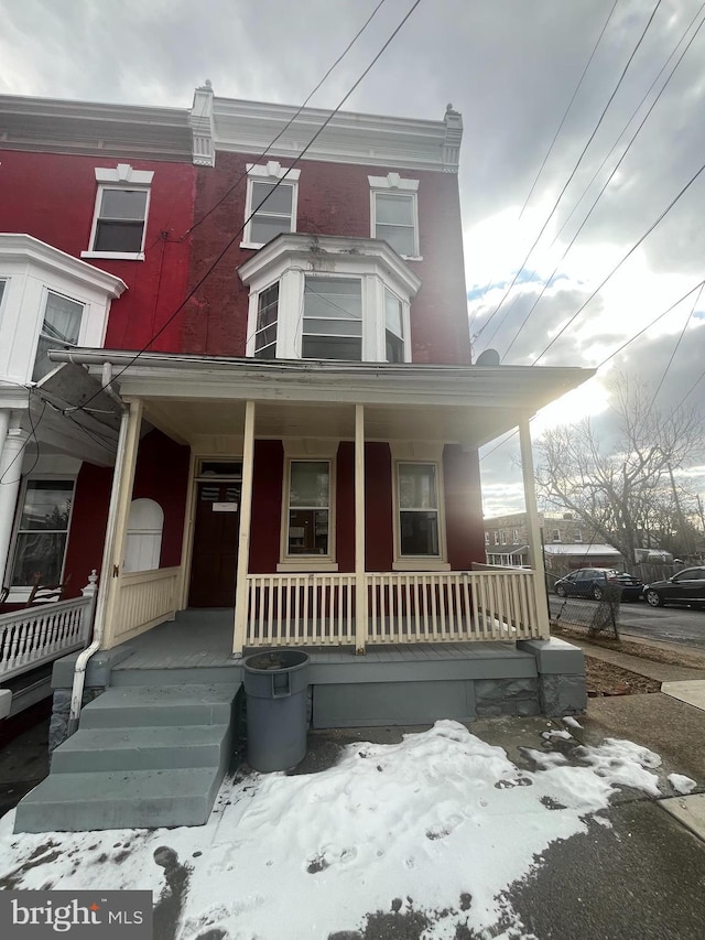 townhome / multi-family property with covered porch