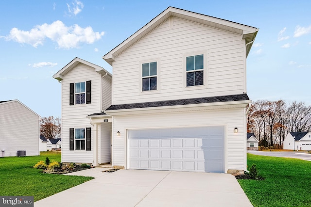 view of front property featuring a front lawn and a garage