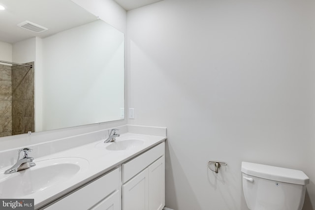 bathroom featuring toilet and vanity