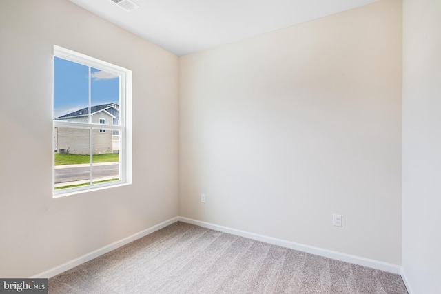 carpeted spare room featuring a wealth of natural light