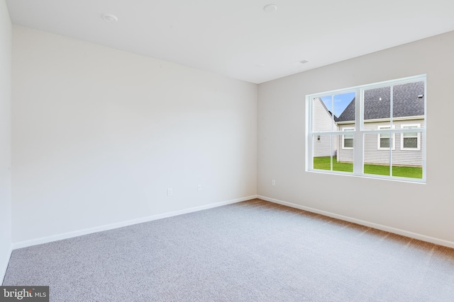 unfurnished room featuring carpet