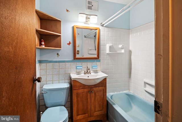 full bathroom featuring toilet, tile walls, tub / shower combination, and vanity