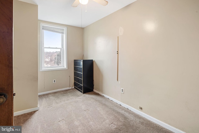 empty room with ceiling fan and light colored carpet