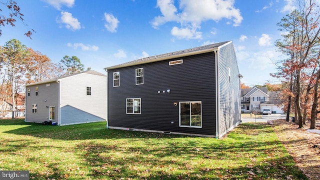 rear view of property featuring a yard