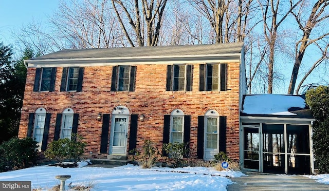 colonial house featuring a sunroom