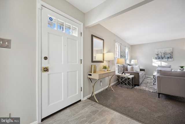 foyer featuring light colored carpet