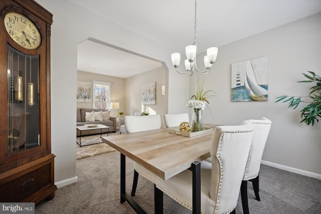 dining space with a chandelier and carpet flooring