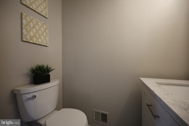 bathroom featuring toilet and vanity