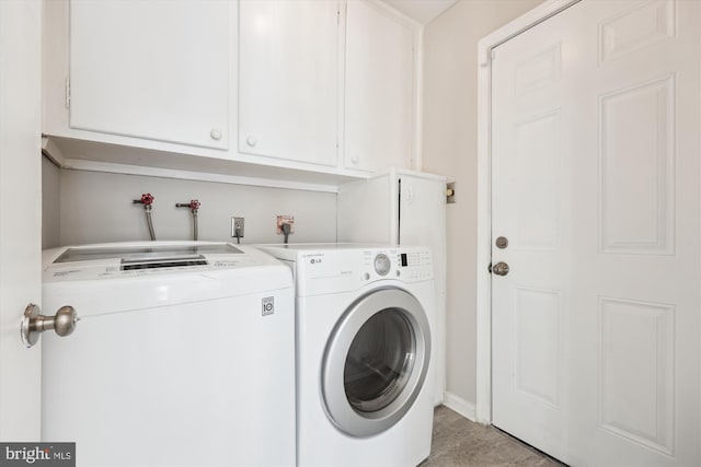 clothes washing area featuring cabinets and independent washer and dryer